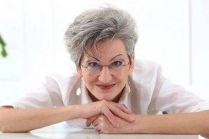 older lady wearing eyeglasses ready for ocular disease management in Wilmington